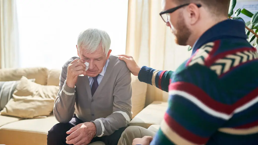 good listener with empathetic psychologist consoling man