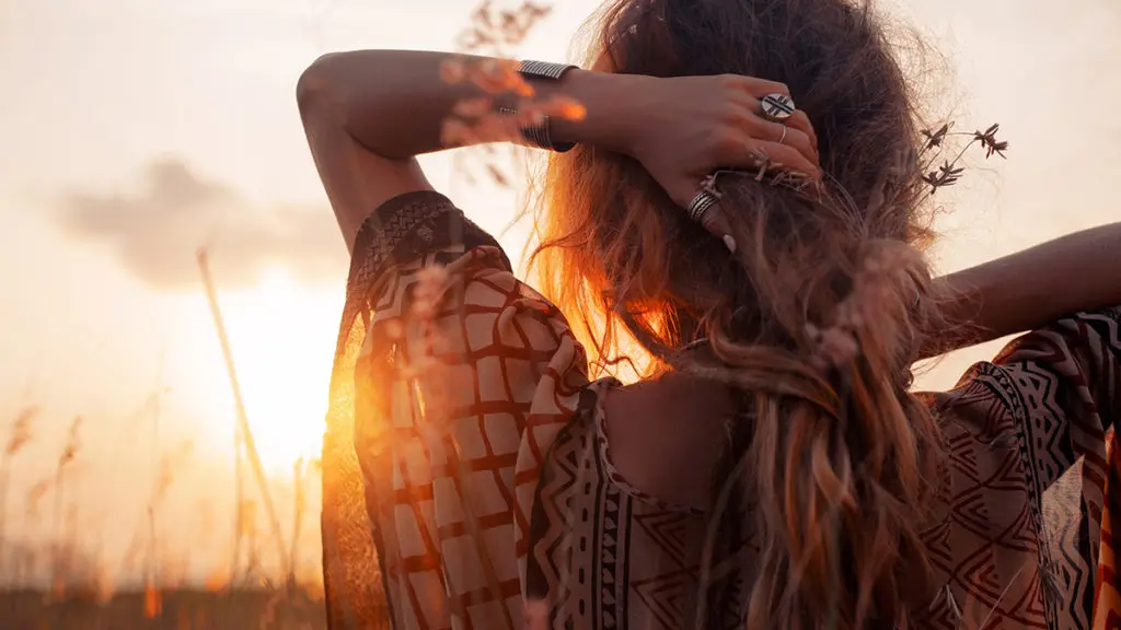 Photo of a young woman at sunset