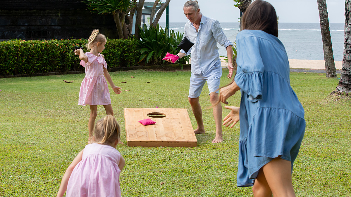 Family playing cornhole