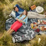 a photo of summer vacation with a couple relaxing at a picnic