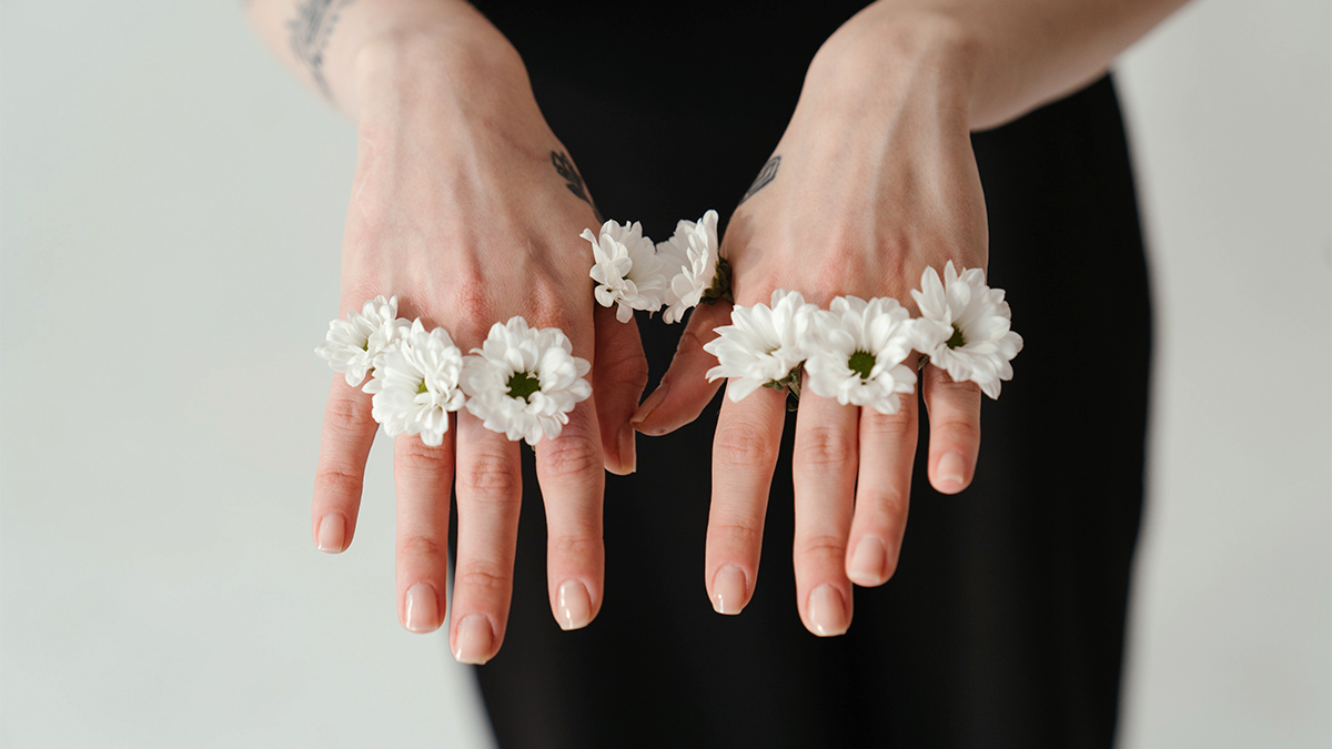 white flowers on hand as rings