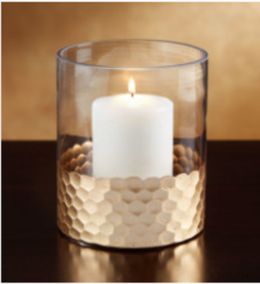 A glass vase reused as a candle holder