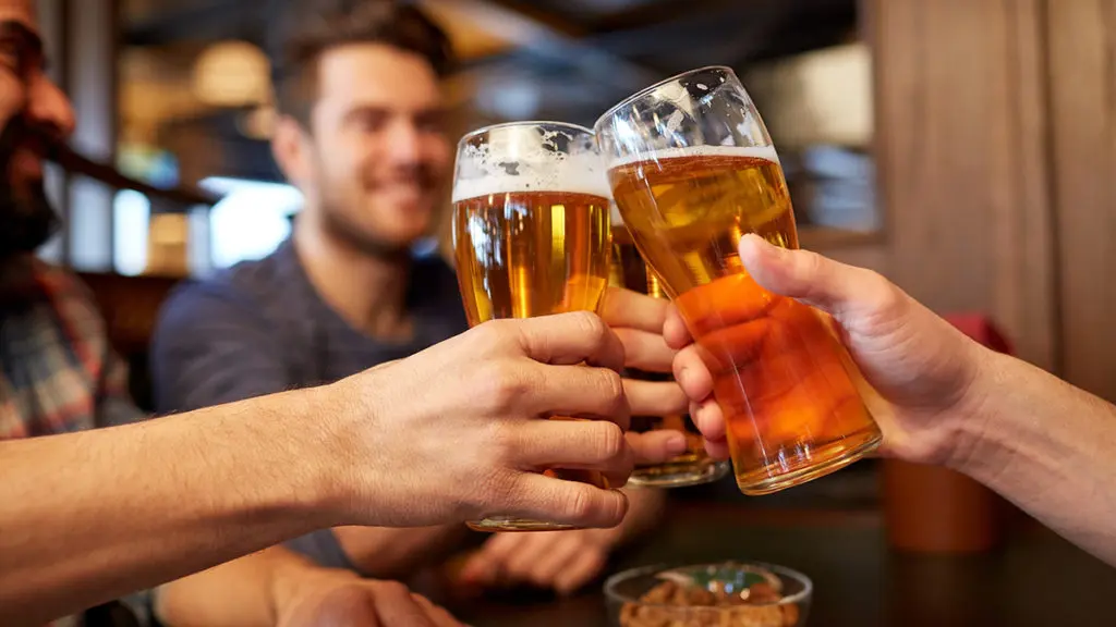 Photo of men enjoying beer while celebrating their September birthdays.