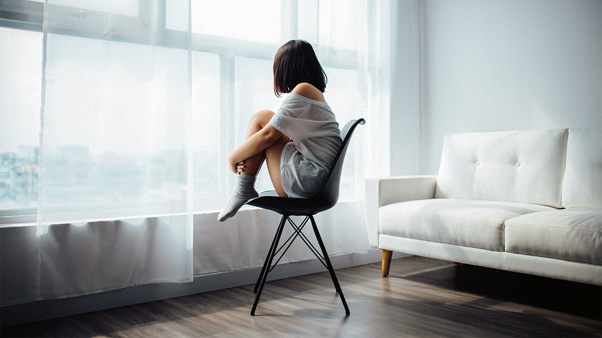Photo of a woman combatting loneliness, sitting in a chair