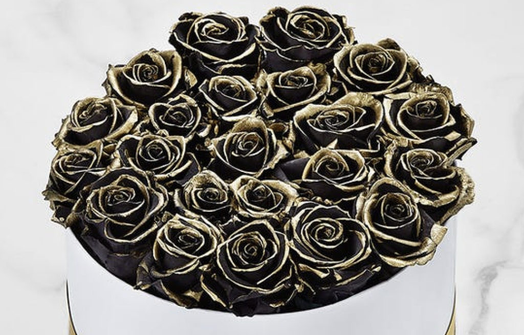 A picture of preserved  black and gold roses