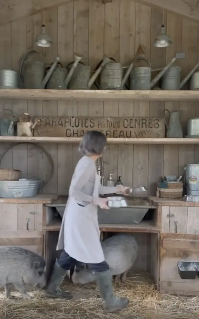 Photo of cottagecore aficionado Brooke Giannetti as she feeds her animals.