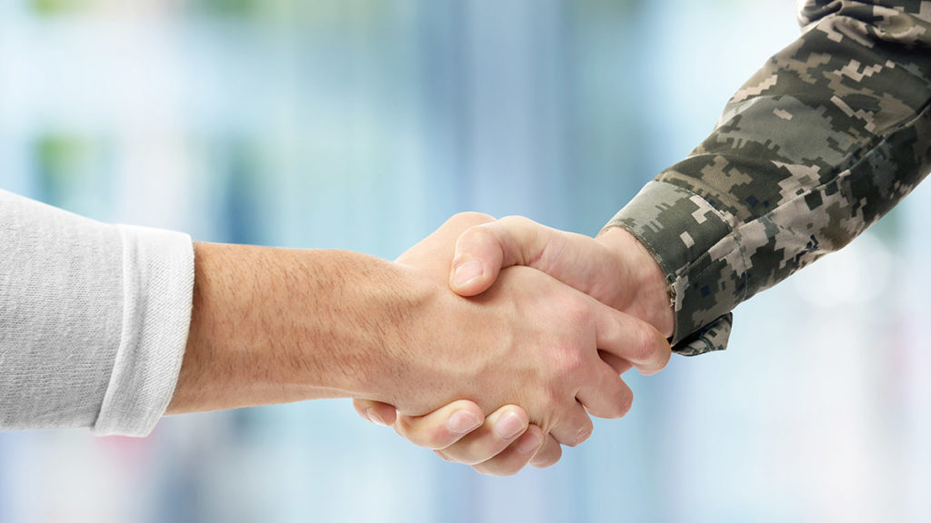 honoring veterans with shaking hands with veteran