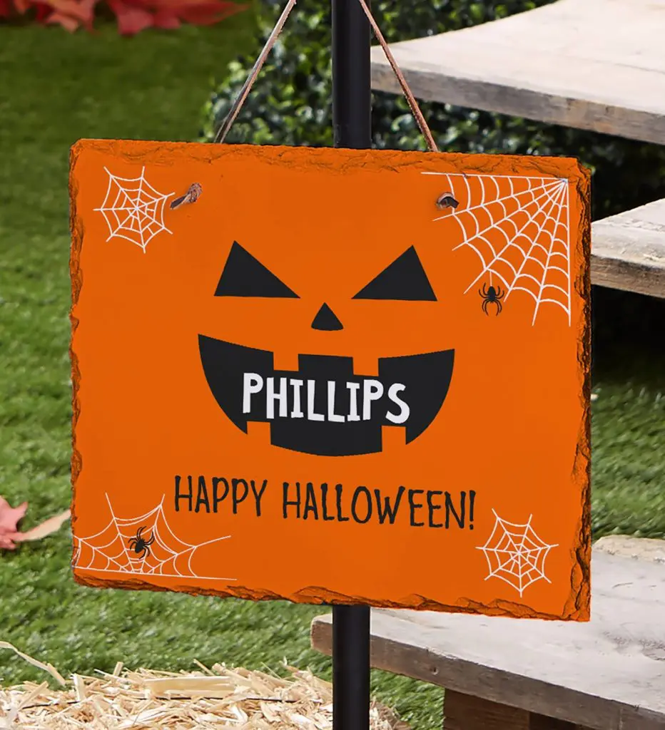 Halloween decor ideas with personalized lawn sign that greets trick-or-treaters