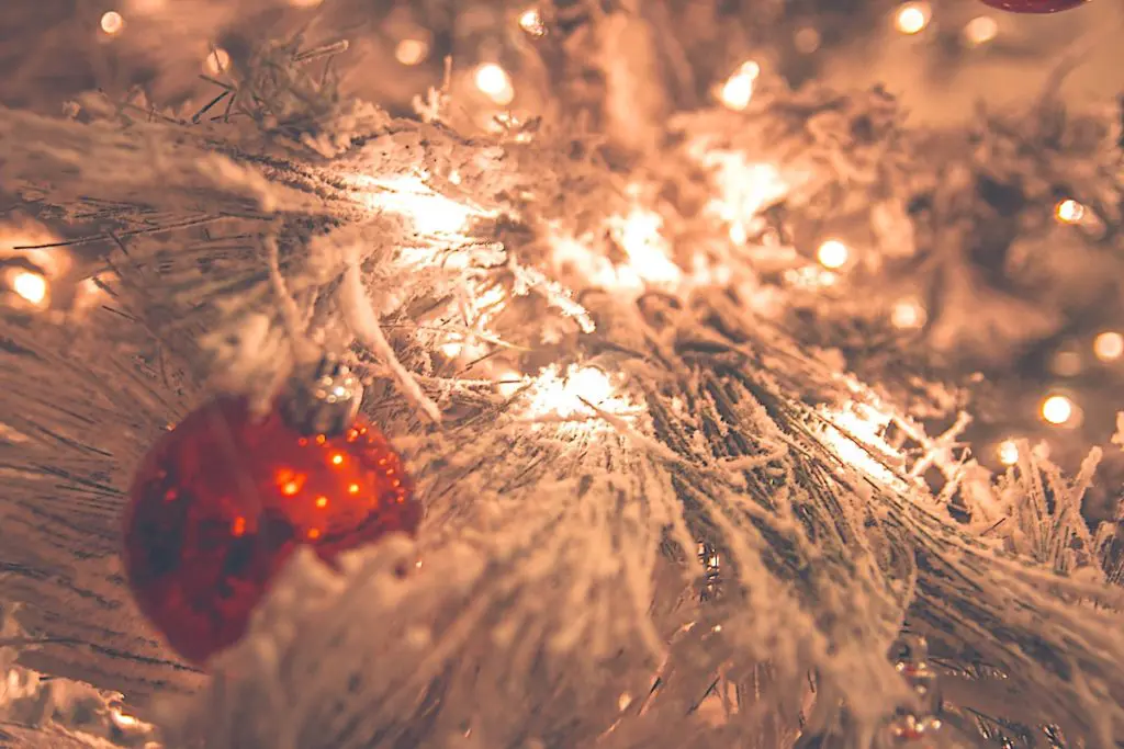 Flocked Christmas tree with red ornament