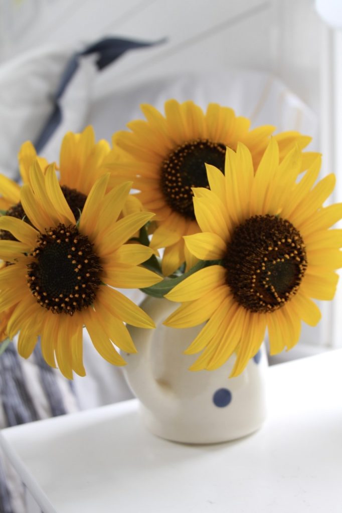 A picture of sunflowers in a guest bedroom