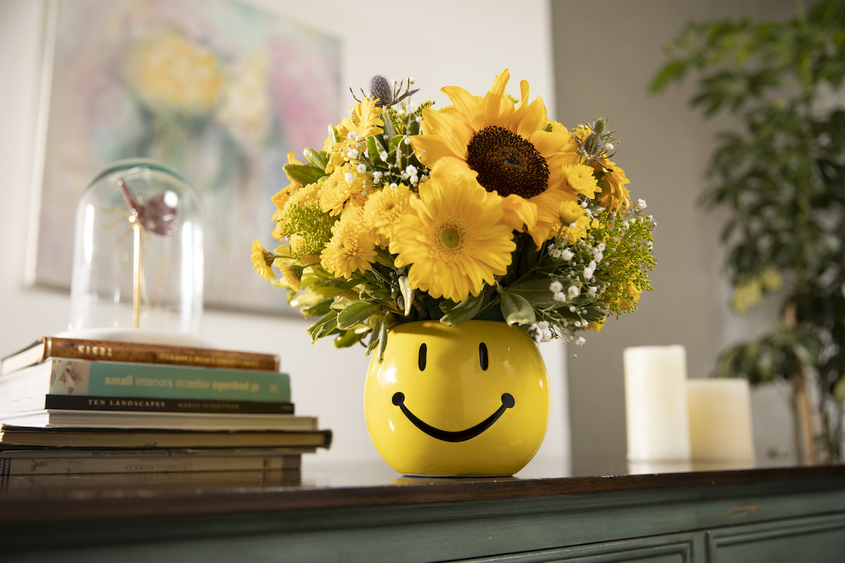 Picture of flowers in a smile face container