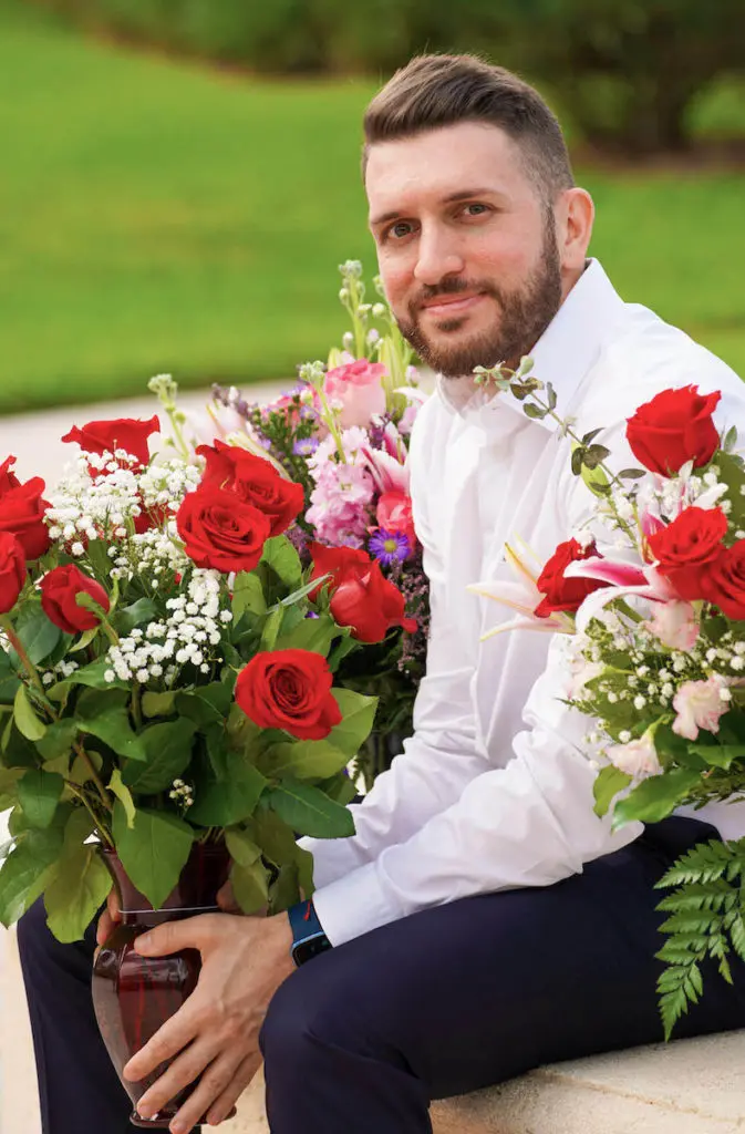 relationship advice with Relationship coach Eros Miranda seated with flowers