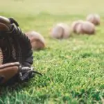 Photo of a baseball mitt and balls, illustrating a love story involving a baseball player.