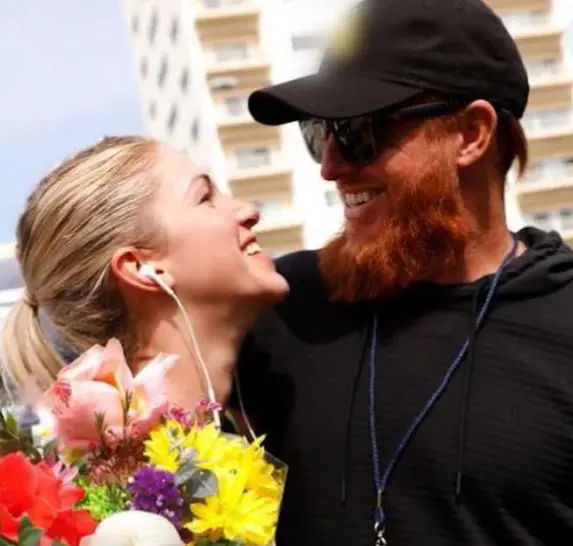 Photo of Justin Turner and wife Kourtney Turner as they celebrate their love story with flowers
