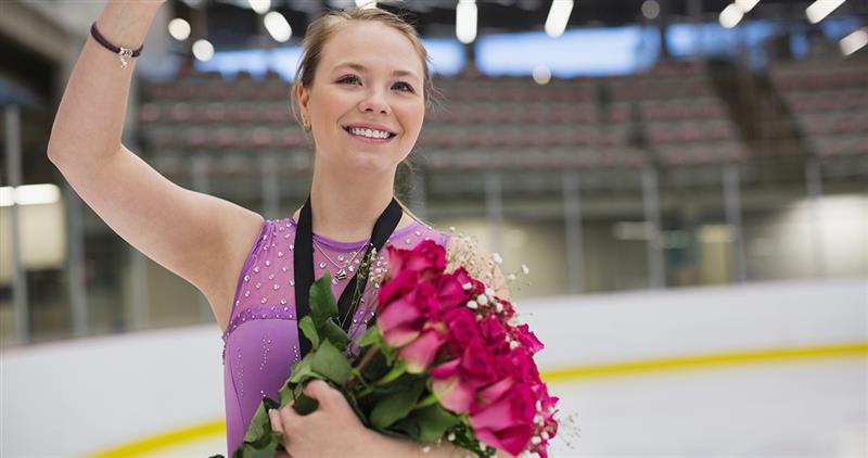 Photo of ice skater with flowers
