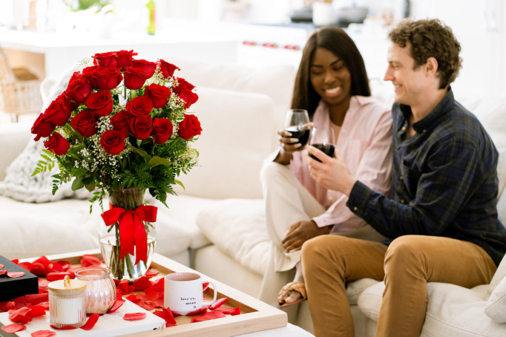 Couple with red wine and roses