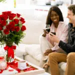 Couple with red wine and roses