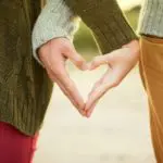 Picture of couple making a heart with hands