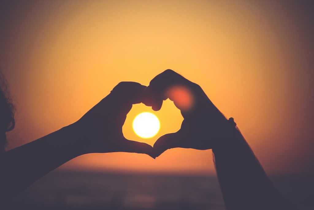 Picture of couple making a heart with hands