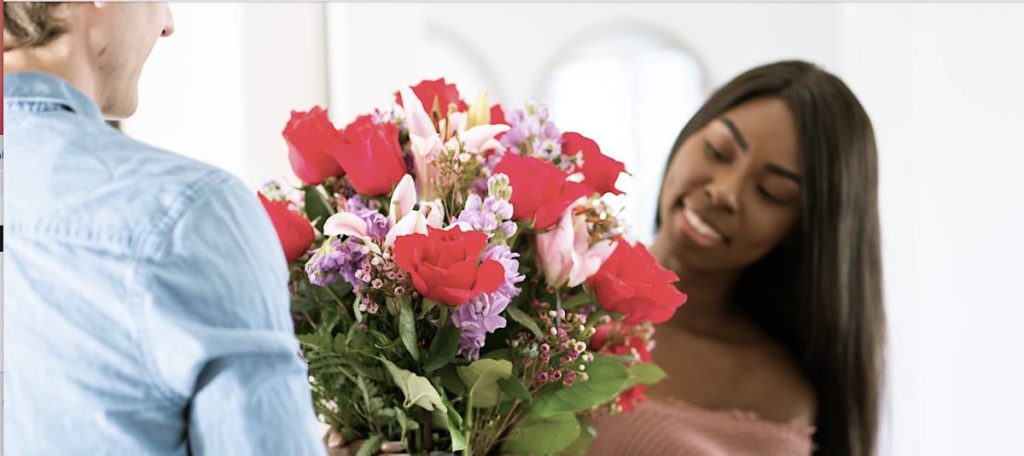 Picture of woman receiving a flower arrangement