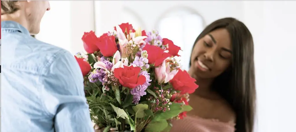 Picture of woman receiving a flower arrangement