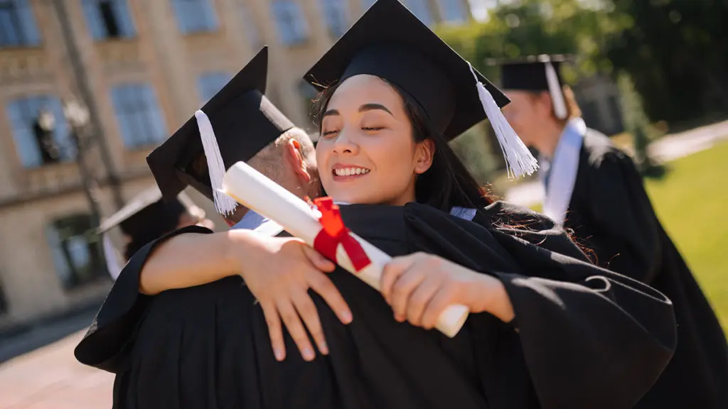 Celebrations Community: Father and daughter hugging at graduation