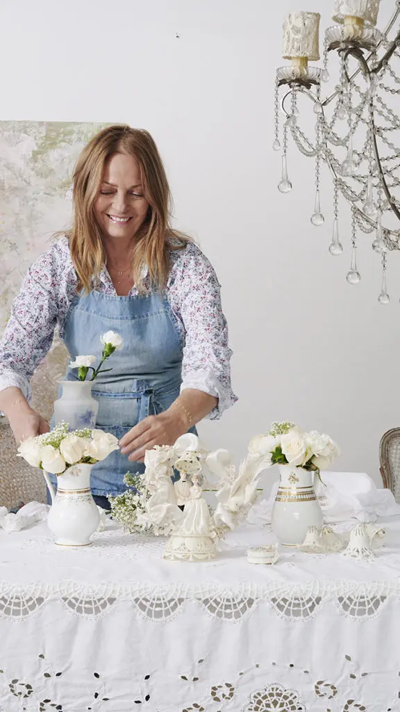 Photo of Rachel Ashwell of Shabby Chic fame arranging white flowers