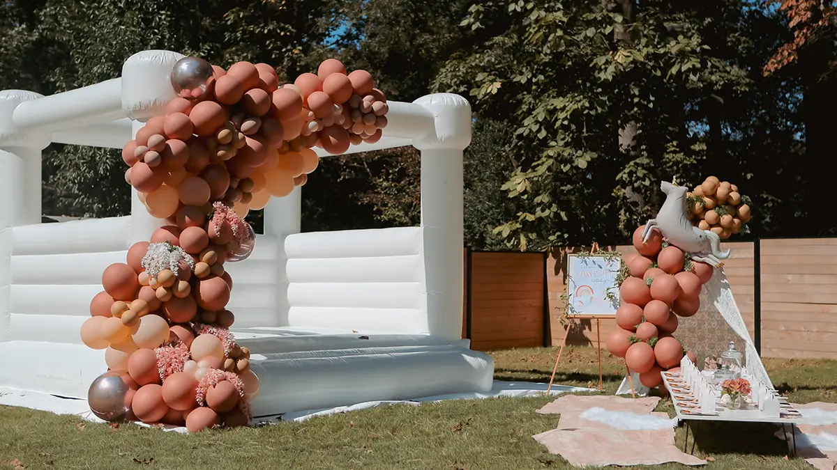 a photo of a unicorn birthday party: bounce house