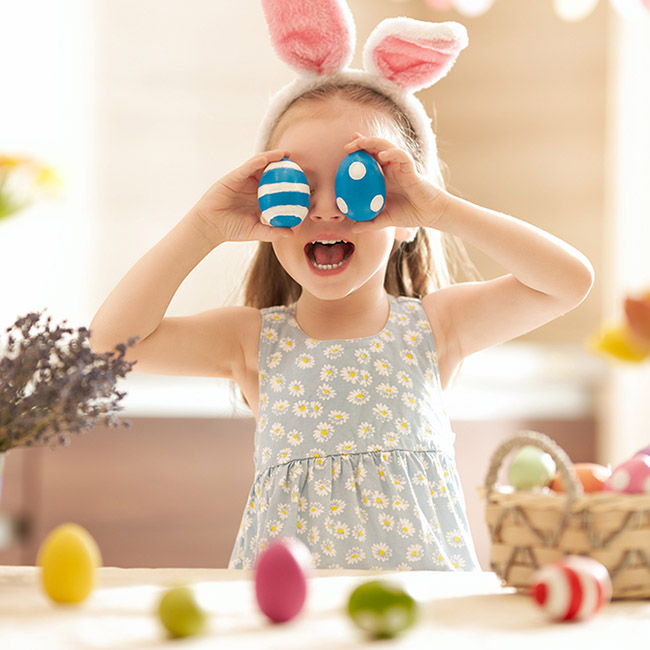 photo of easter egg hunt ideas: girl playing with easter eggs
