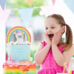 a photo of a unicorn birthday party: girl celebrating at unicorn party