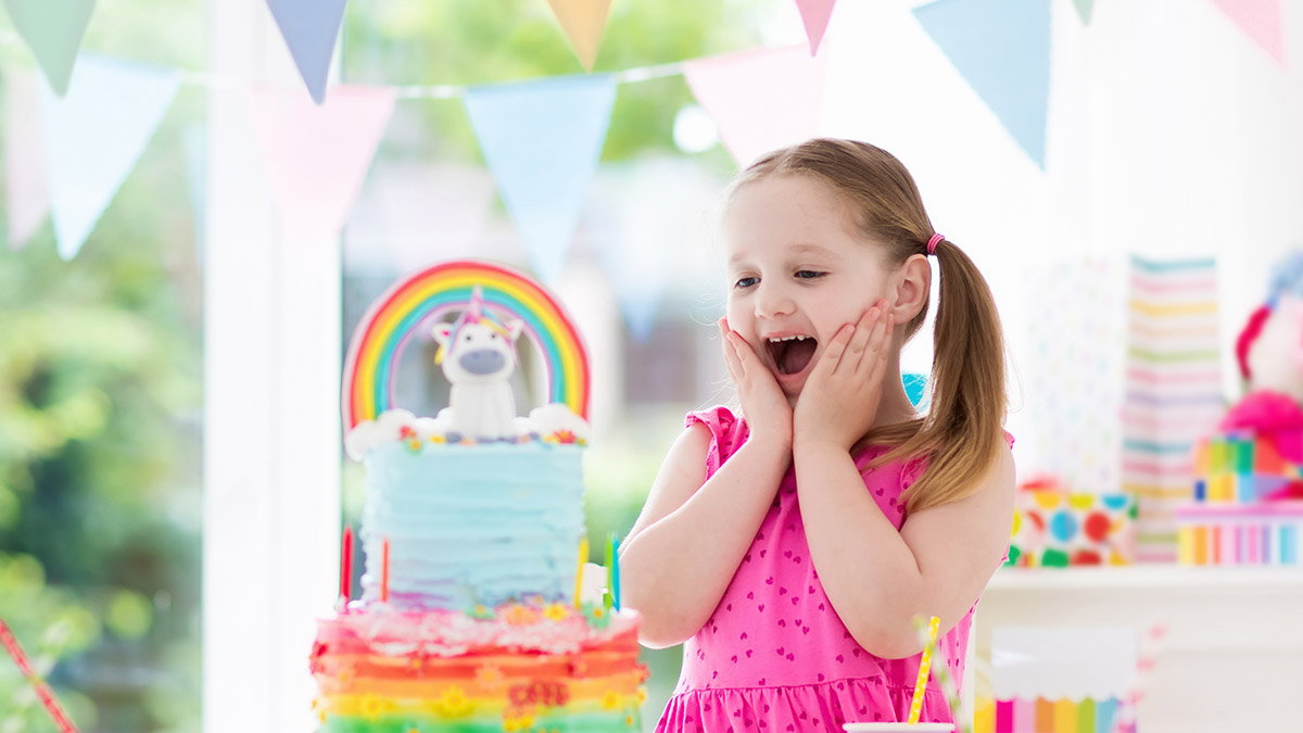 a photo of a unicorn birthday party: girl celebrating at unicorn party