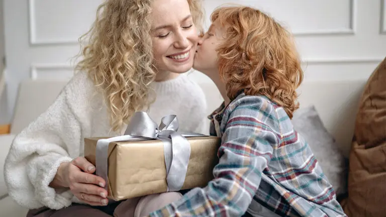 Photo of a small child giving his mother a gift. A photo of a small gift. Gift giving is an important part of human evolution.