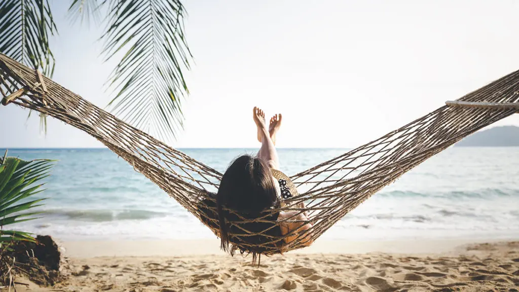 40th birthday ideas with woman relaxing on the beach