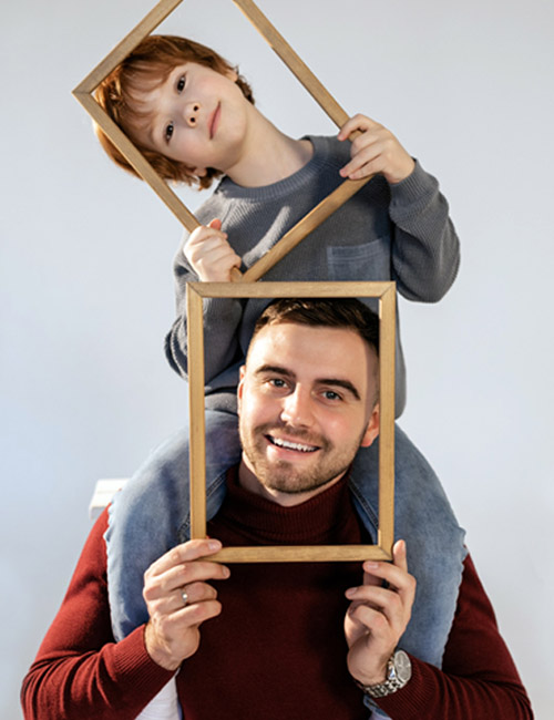 a photo of mother's day ideas: father and son with picture frames