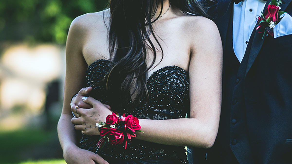 a photo of prom corsage with a promgoer wearing a wrist corsage