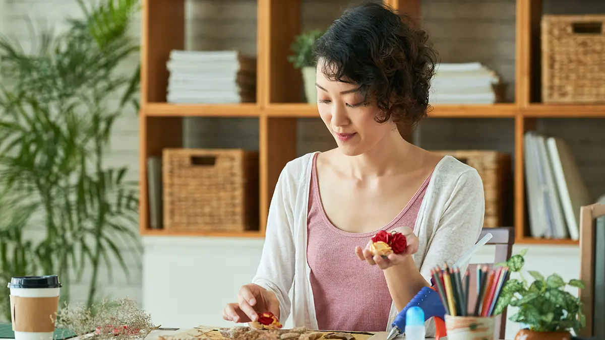 a photo of rose month with a woman pressing roses