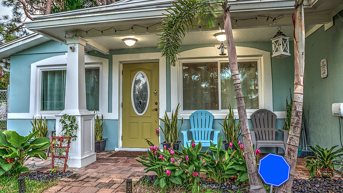 A photo of front porch ideas with a tropical-looking front porch