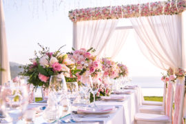 A photo of summer wedding flowers with a table setting at a luxury wedding