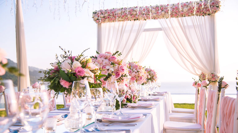 A photo of summer wedding flowers with a table setting at a luxury wedding