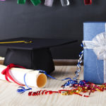 A photo of best graduation gift ideas with a present next to a graduation cap