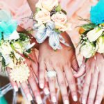 a photo of corsages on wrists