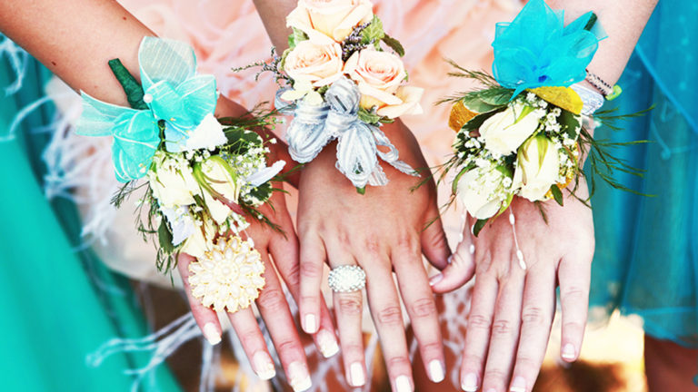 a photo of corsages on wrists