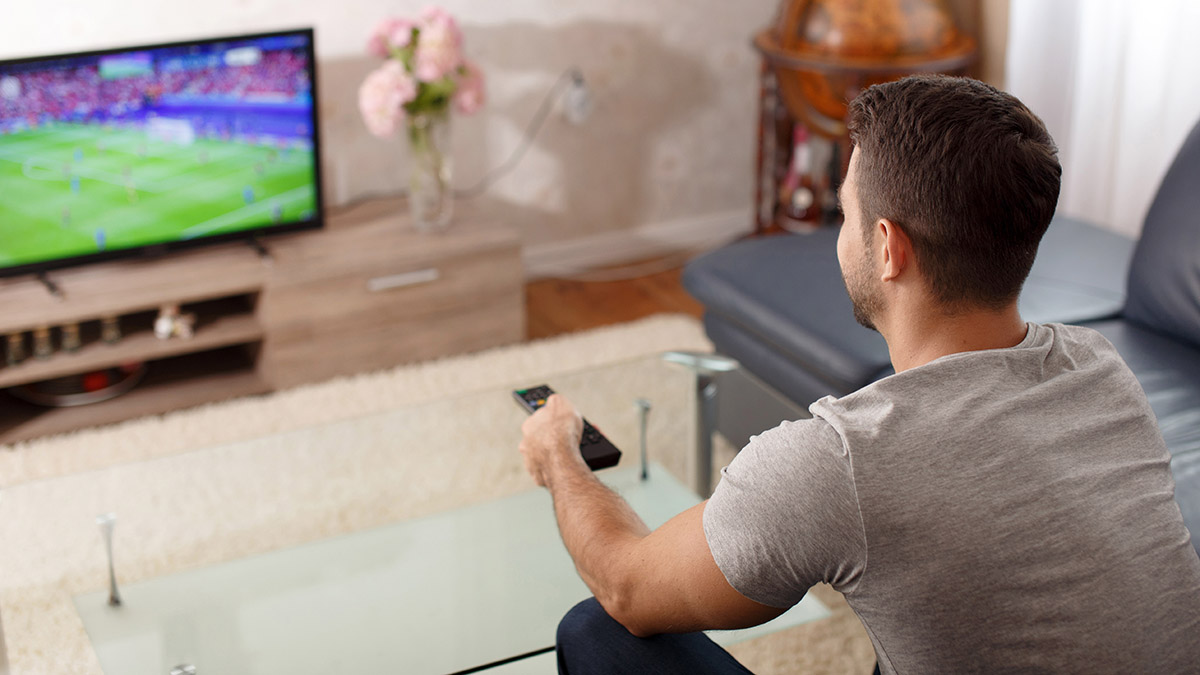 A photo of celebrate father's day with dad watching sports on tv