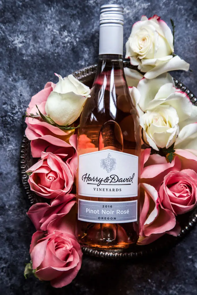 a photo of Rosé Cocktail with a bottle of pinot noir rosé wine and pink and white roses
