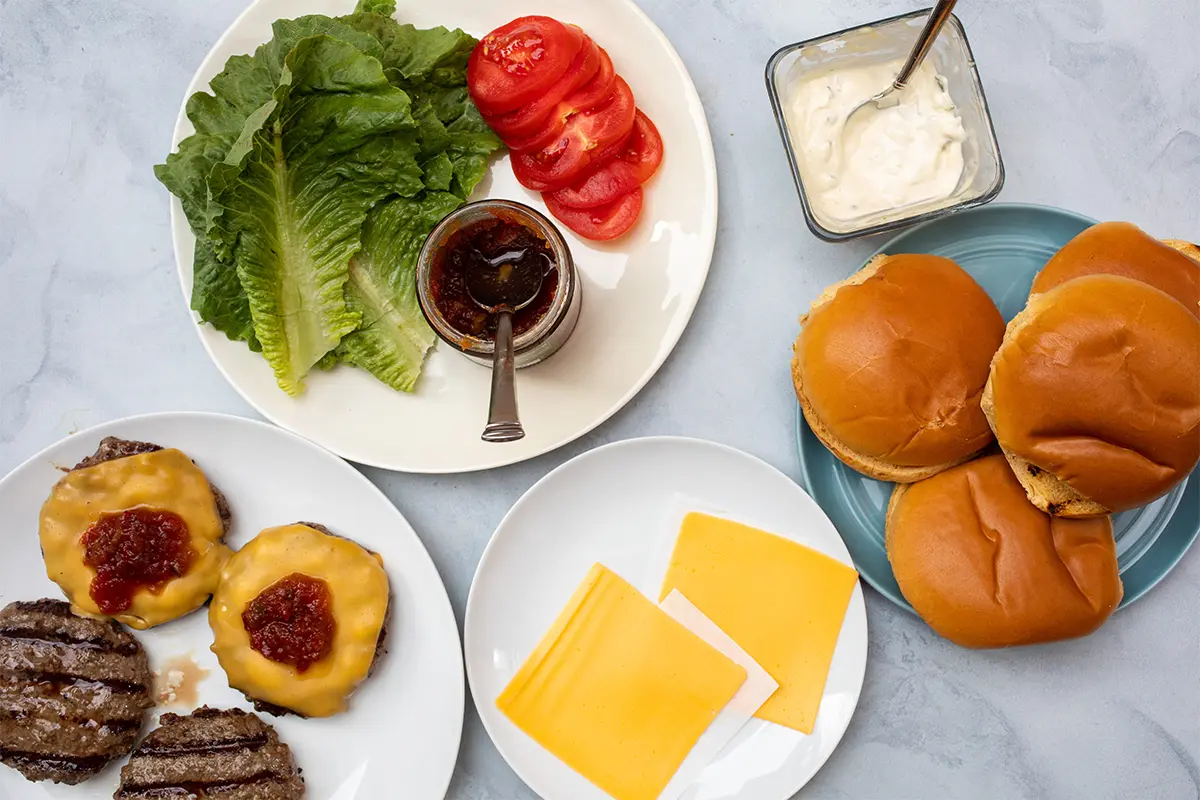 a photo of grill burgers with burger toppings