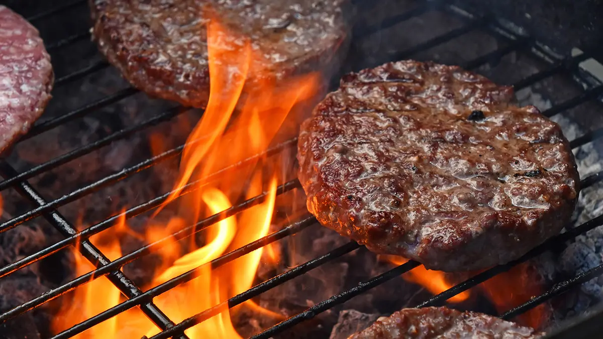 a photo of grill burgers with burgers on a grill