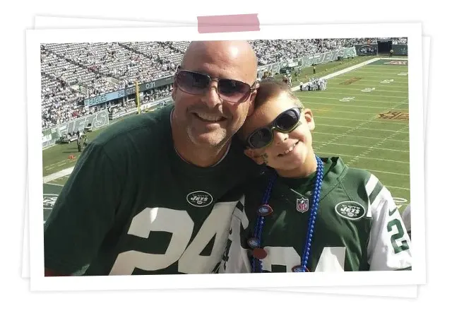 Photo of dad and son enjoying football game