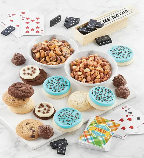 A photo of father's day gift ideas with a plate of cookies and two bowls of nuts surrounded by cards and dominoes
