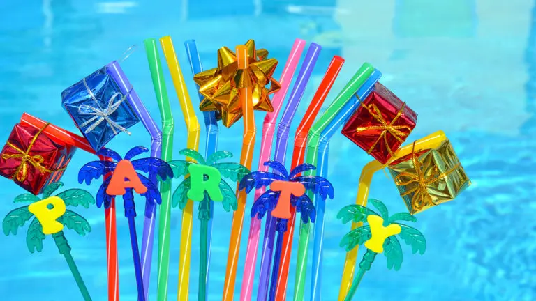 august birthdays with party decorations and colored tubules on the swimming pool background