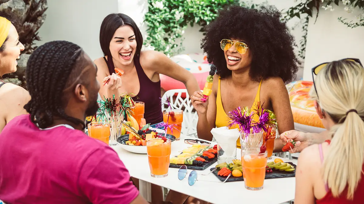 photo of alt bash with group of friends talking and laughing at lunch